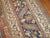 An early 20th century doroksh rug. The field is terracotta, the border is navy, light green, mustard, light blue, ivory...