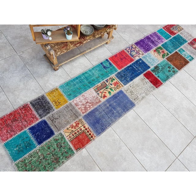 This is a vintage Turkish Oushak rug from the Mid 20th Century. The piece was hand-knotted.