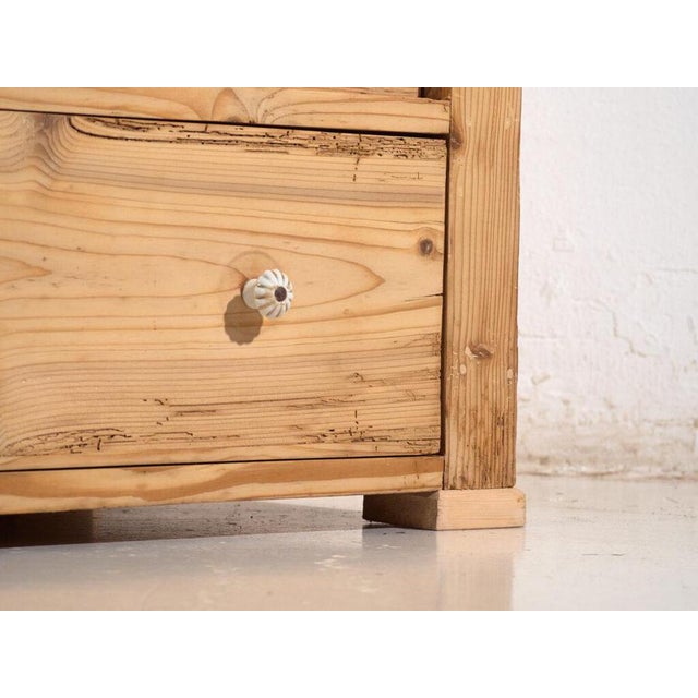 Chest of drawers in stripped pine, originally from central europe and dated to the early twentieth century. A piece of...