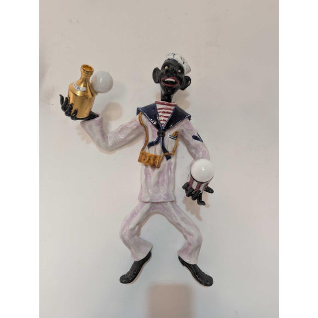 Striking 1950s Venetian wall sconce crafted in polychrome glazed ceramic, depicting a theatrical sailor figure. Made in...