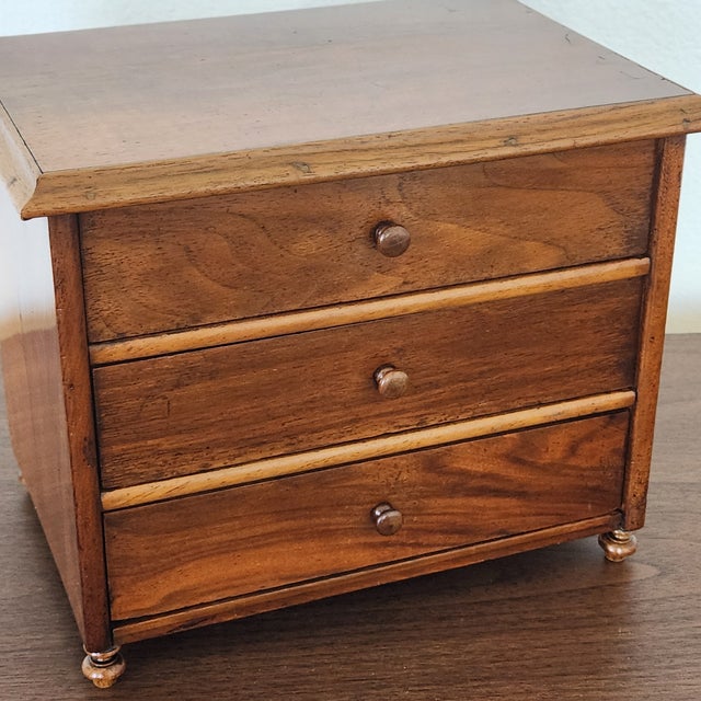 This is a lovely little [Walnut? veneered?] chest of 3-drawers. It appears to be quite old ~ most likely an antique (as...
