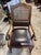 This vintage Drexel Heritage arm chair features a cane and leather backrest which is slightly arched. In the Regency...