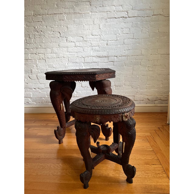Carved octagonal Anglo-Indian hardwood side table, with stylized carved elephant head legs and bone tusks. Floral motif...
