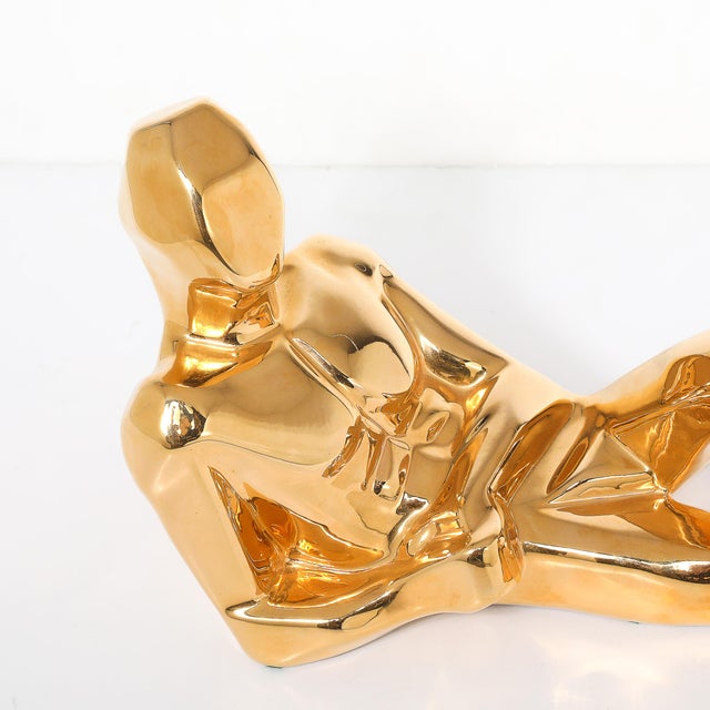 This Mid-Century gold-plated ceramic sculpture, depicting a reclining man, is an iconic work of American design signed...