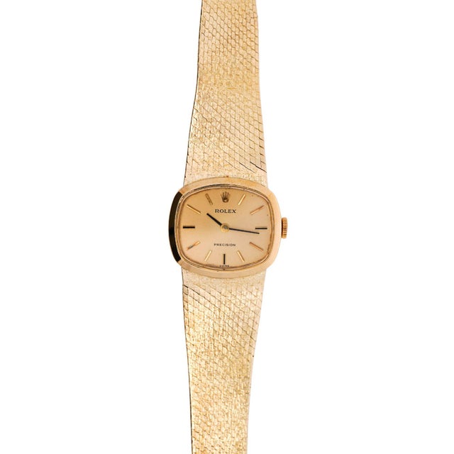 Vintage Rolex Precision ladies manual-wind watch in 18K yellow gold featuring a cushion-shaped case with a champagne...