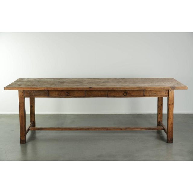 This beautiful antique farmhouse dining table dates from the 19th century, is made of pine, and has a very charming,...