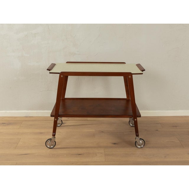 Wonderful serving trolley from the 1950s. High-quality solid wood frame made of walnut with a shelf in walnut veneer, a...