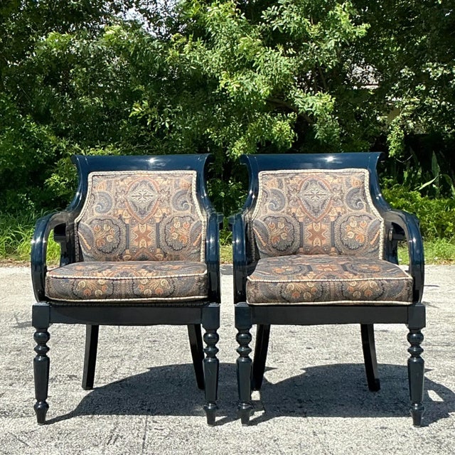 The Vintage Regency Navy Lacquered Paisley Lounge Chairs are a stunning pair that combine bold elegance with a touch of...
