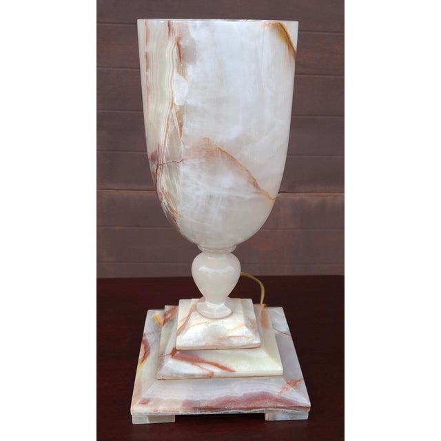 A vintage onyx marble table lamp, featuring a warm amber glow when illuminated. Material: Carved from natural onyx marble,...