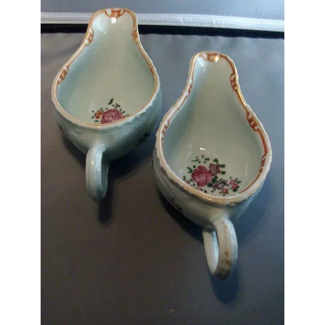 A fine pair of 18th century Chinese Export Porcelain sauce boats painted inside and out with sprigs of flowers....
