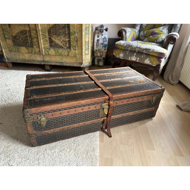 Signs of use consistent with age. Wear to the canvas, leather, wood, and brass hardware with scratches, scuffs, stains,...