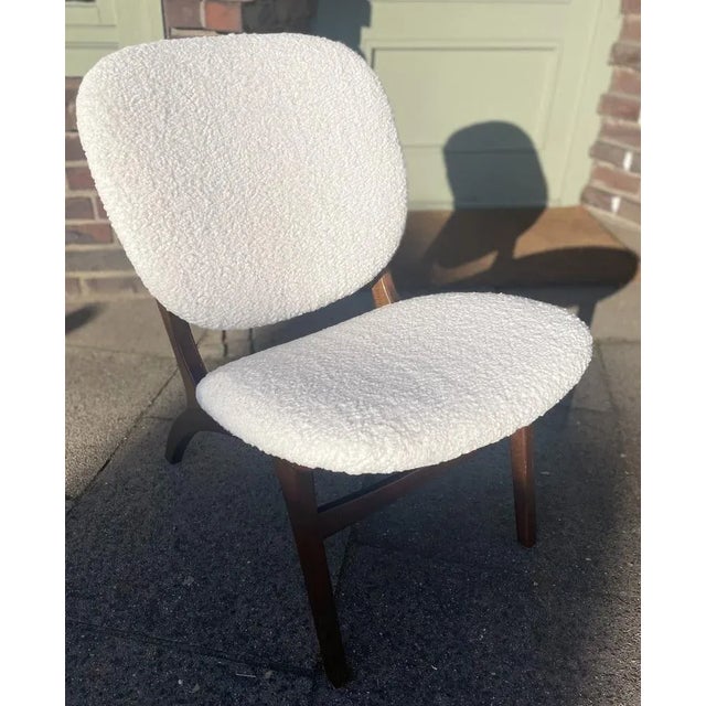 A beautiful pair of Danish furniture pieces: gorgeous dark wood and light bouclé fabric combination One armchair with an...