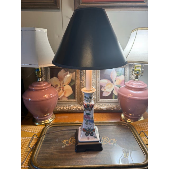 Vintage Chinese Famille Rose candlestick-style porcelain table lamp, featuring a hand-painted butterfly and floral motif...