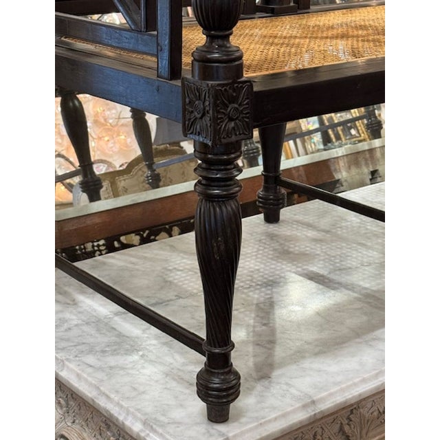 This is an early 20th-century Continental-style settee with carvings and an ebonized finish. The settee features a...