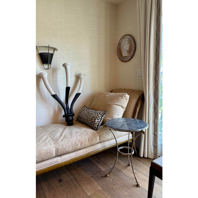 A rare, sleek pair of Parisian-Art Deco sconces with black arched perforated metal and contrasting brass architectural...