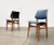 Elegant Mid Century chairs with blue imitation leather upholstery. The frame of the chairs is composed of solid wood...