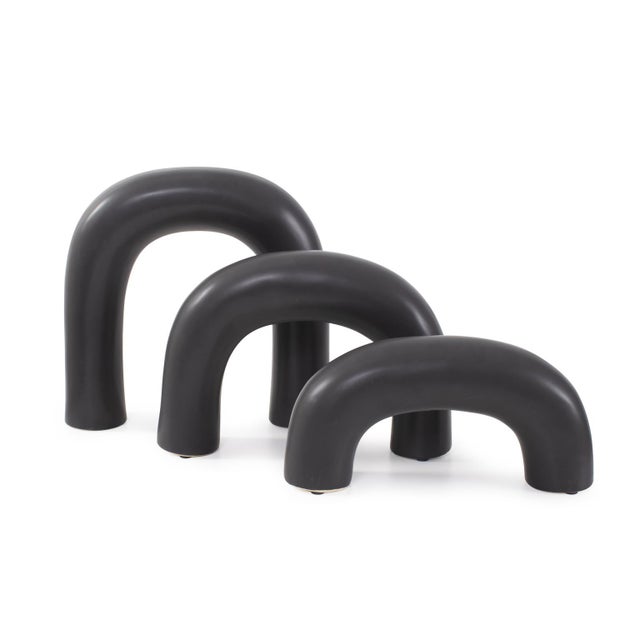 A set of three sleek and modern arched sculptures in matte black. Designed for versatility, these sculptures can be...