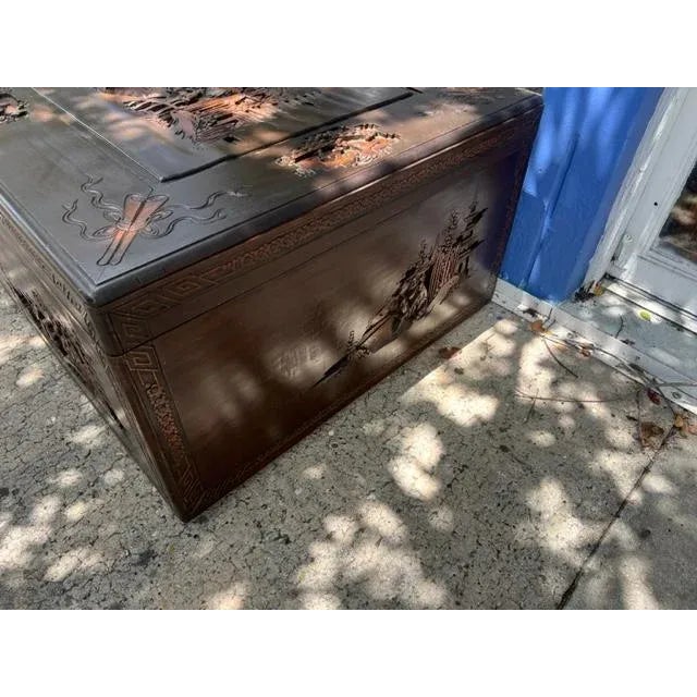 This is a huge camphorwood trunk which would make a great coffee table. Superb carvings of people brass latch to the...