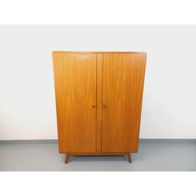 Vintage 1960s oak wardrobe with splayed legs and ample storage: two doors with one key, a large hanging rail, a large...