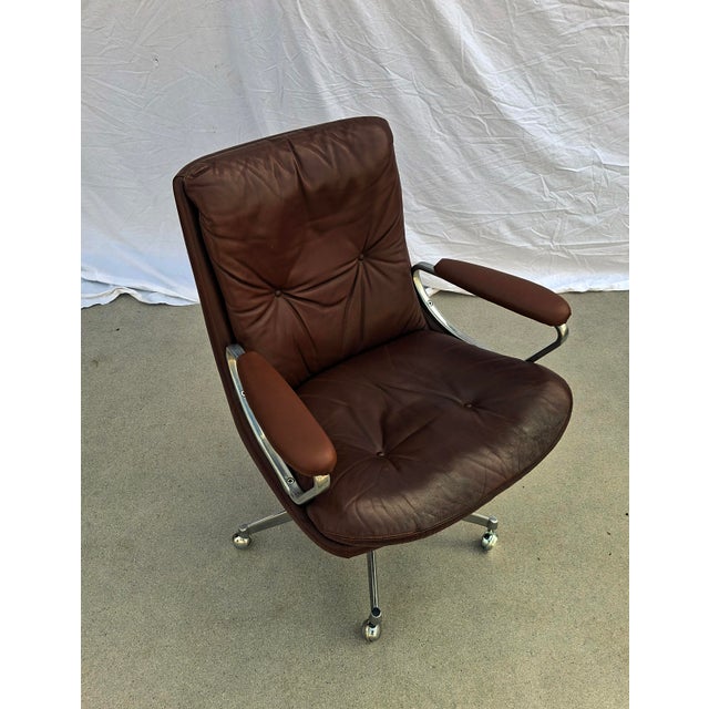 Office chair on casters. Full leather upholstery on the seat, front and back of the backrest, and armrests (the leather on...