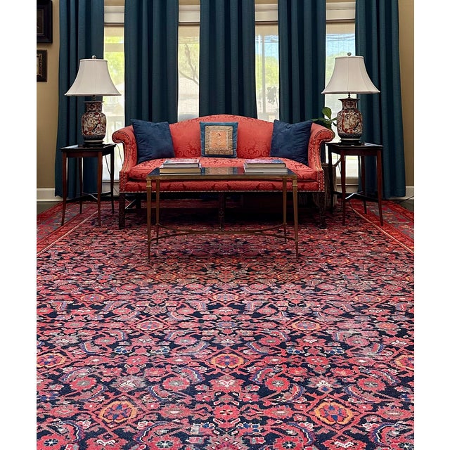 A beautifully constructed vintage sofa in the English Chippendale tradition, distinguished by its carved hardwood base...