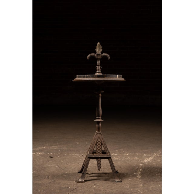 Striking floor-standing smoking stand featuring a heavily cast iron base with bold geometric and chevron-patterned...