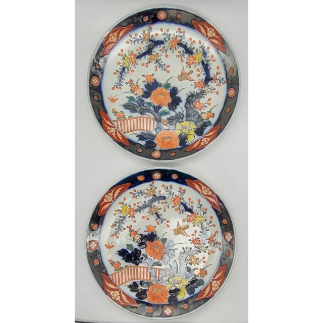 In traditional Imari colors, white porcelain backdrop, with a bold border. Each feature the same floral scene with bird in...