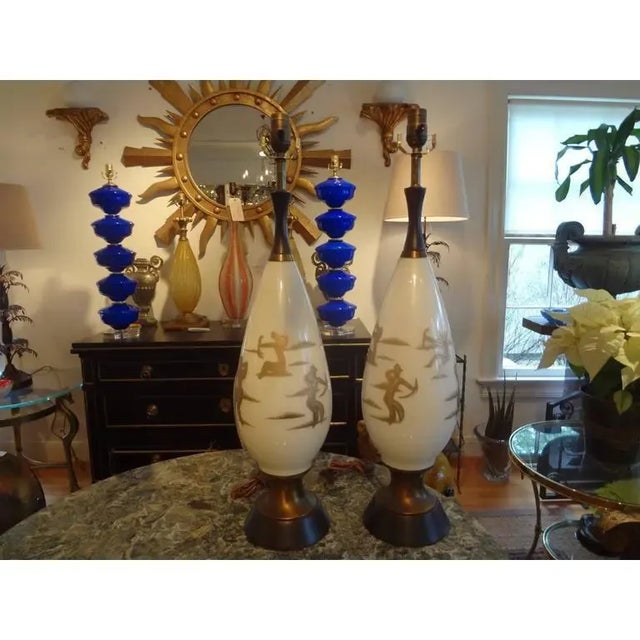 Pair of Hollywood Regency Gerald Thurston Style Gilt Decorated Glass Lamps Chic pair of Mid-Century Modern white glass...