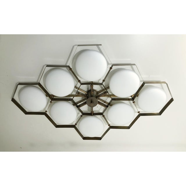 Italian midcentury flush mount with eight matte white Murano glass shades mounted on solid brass frame in bronze finish /...