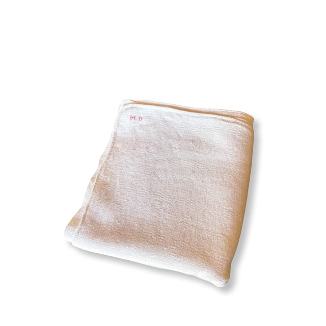 An exceptionally soft antique French cotton coverlet dating to circa 1900, with the gentle weight of a summer blanket and...