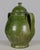 A large green glazed earthenware lidded jar made in Portugal. Beautiful rustic green drip glaze. Bulbous body, arched loop...