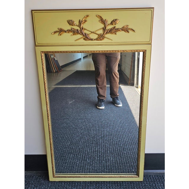 A Continental Partial Gilt and Green Painted and Decorated Frame Mirror Measures 24.5" in width x 41.5" in height.