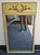 A Continental Partial Gilt and Green Painted and Decorated Frame Mirror Measures 24.5" in width x 41.5" in height.