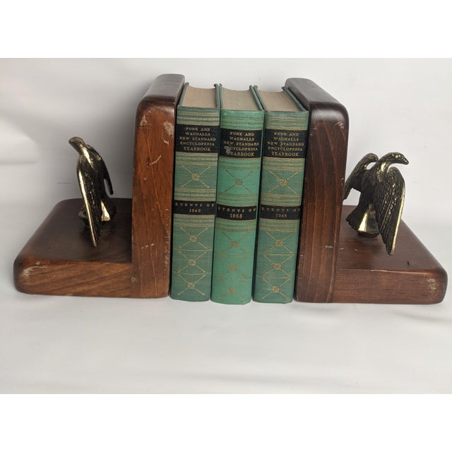 A charming collection of three mid-century Funk & Wagnalls encyclopedia yearbooks from 1948, 1949, and 1955, featuring...