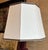 Octagonal lampshade out of an ivory pongee silk with a dark brown patterned trim on the top and bottom, with a drop in...