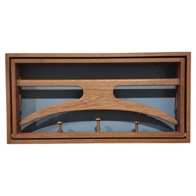 Danish modern wall-mounted folding valet crafted in solid teak, attributed to Adam Hoff and Poul Østergaard. The compact...