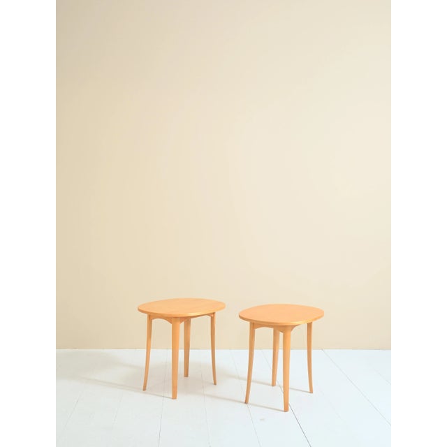 Pair of birch wood bedside tables designed in the 1960s by Carl Malmsten, as reported by the authenticity stamp. The soft...
