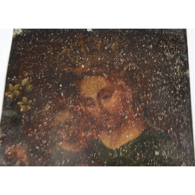 Featured is a Mexican Folk Art retablo dating to the late 19th century. This retablo features oil paint on a sheet of tin...