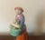 Antique early 19th century English Regency Staffordshire figure of a lady baker or fruit seller. Dressed in bright colors...