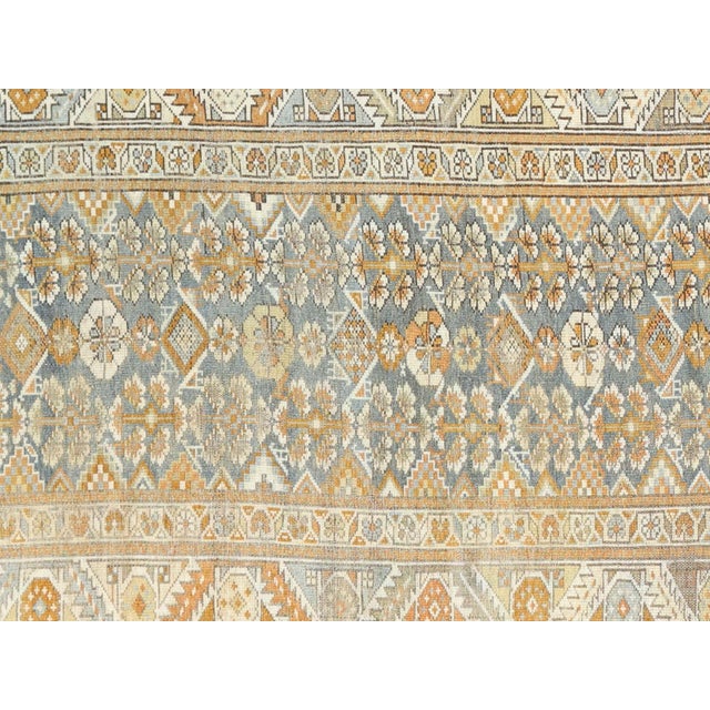 This Antique Persian Melayer Runner boasts an elegant design and durable construction, with dimensions of 3'4" x 10'1"....