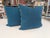 Pair of New Moon 22" square pillows with front featuring a navy blue linen fabric with teal medallions, pale teal piping...