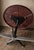 An original vintage coffee table from England, featuring a circular phenolic top, presumably Bakelite, featuring a...