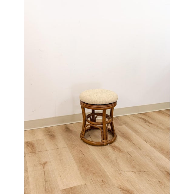 This lovely vintage upholstered rattan swivel stool is a practical and stylish coastal and boho accent seating find. The...