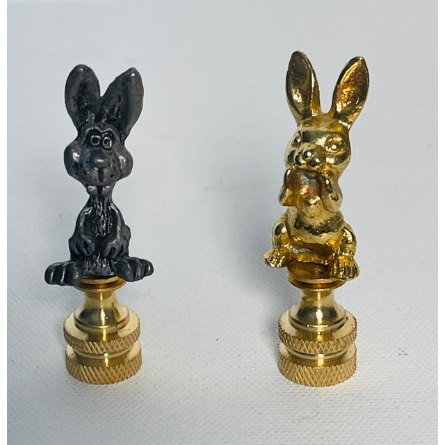 Whimsical pair of brass and metal rabbit figurines as lamp finials.