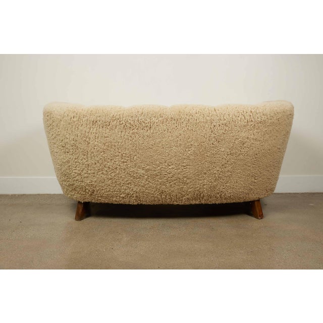 Introducing a stunning Vintage Cabinetmaker Settee from Denmark, circa 1960. This curved 3-seater settee is a prime...