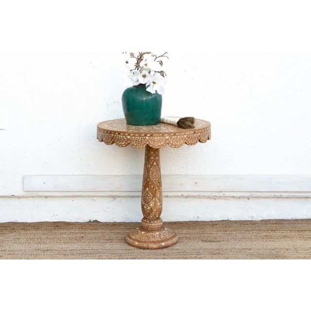 This small table is a masterclass in delicate woodworking. It features a rare scalloped "pie crust" edge, a detail that...