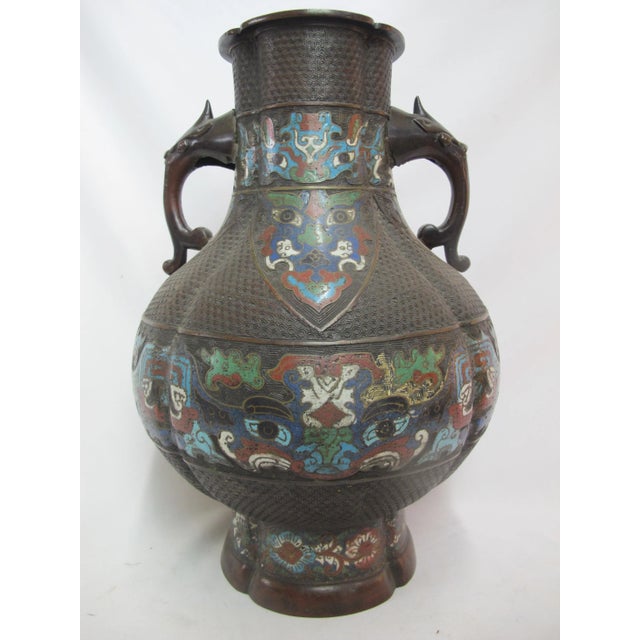 Late 19th century to early 20th century Chinese Bronze and Champleve urn with turquoise, cobalt, red, and green enamel...