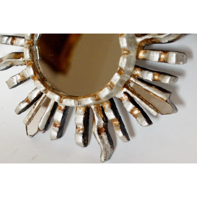 Late 20th-Century silver and gilt sunburst mirror from Peru. This lovely carved wood mirror has a decorative surround of...