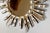 Late 20th-Century silver and gilt sunburst mirror from Peru. This lovely carved wood mirror has a decorative surround of...