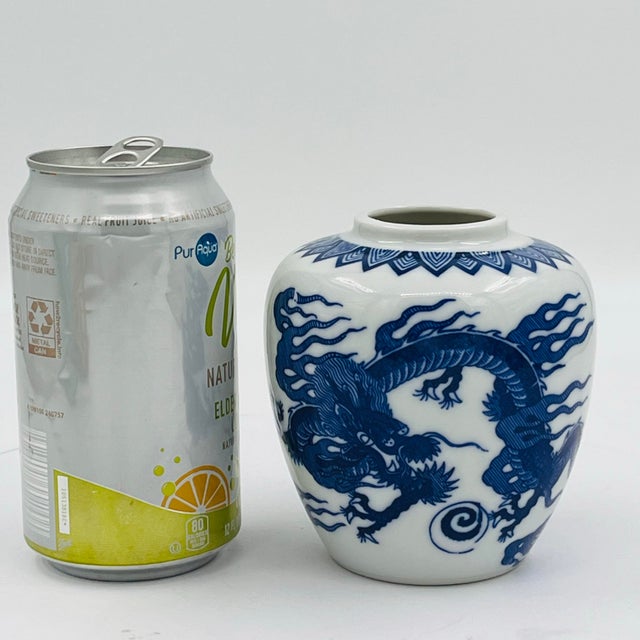 Vintage Japanese blue and white porcelain ginger jar vase featuring a striking dragon transferware design. The piece...